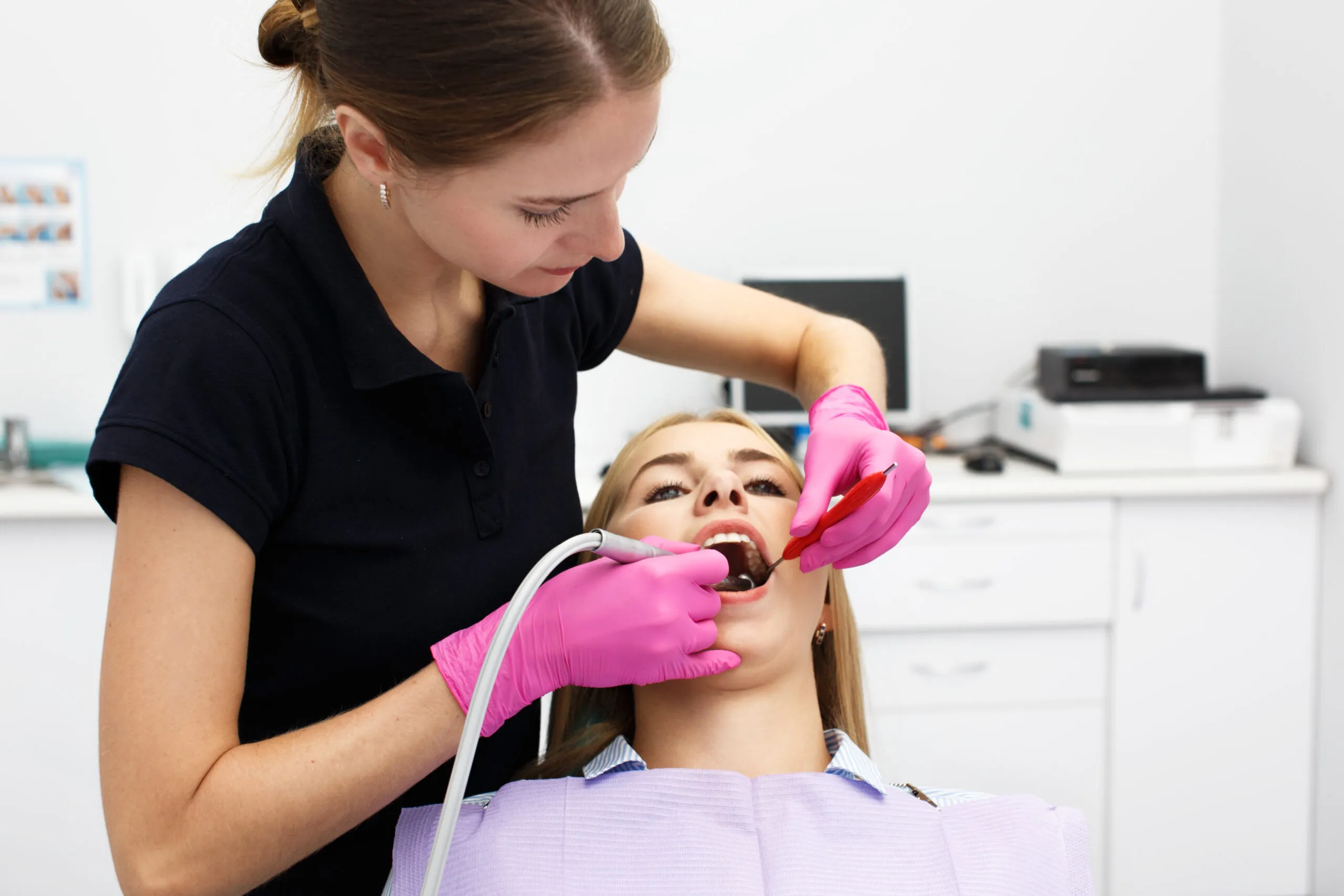 https://65broadwaydental.com/wp-content/uploads/2025/05/female-dentist-treating-her-patient-teeth-scaled.jpg